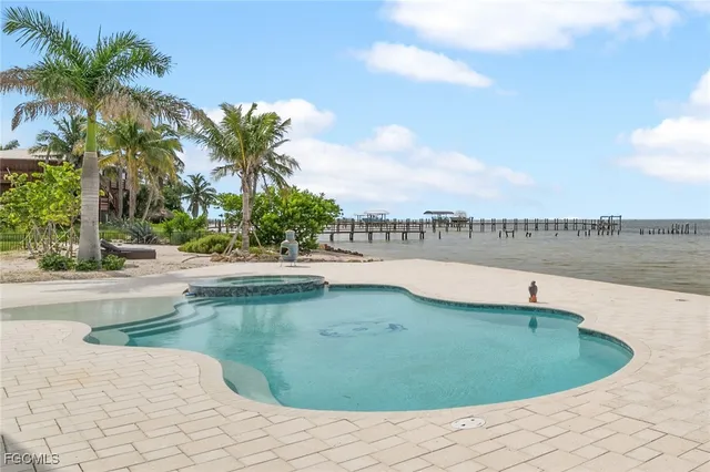 a view of a patio with table and chairs and potted plants