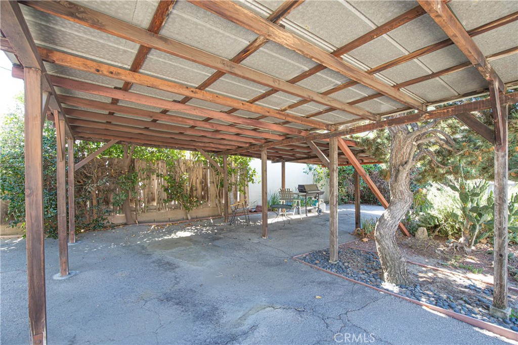 1562 Riverside Drive Glendale, CA 91201 - Photo 18 of 21 a backyard with large trees and a wooden bench