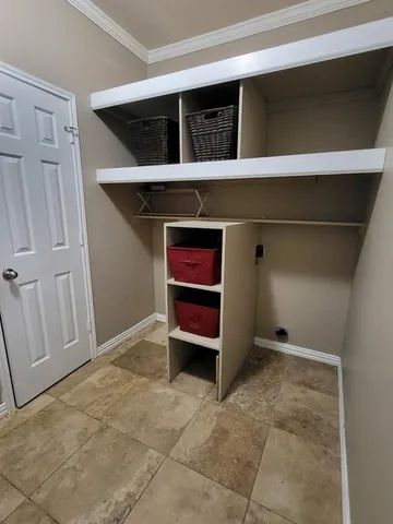 a view of an empty room with a cabinet