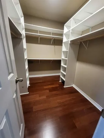 a view of walk in closet with empty racks
