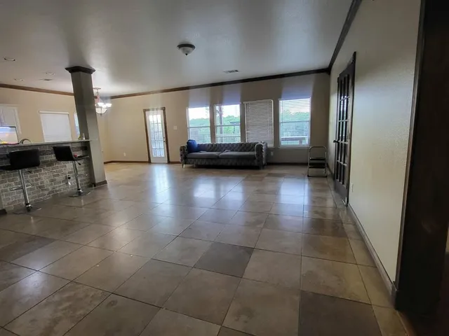 a view of hallway with a couch and a window
