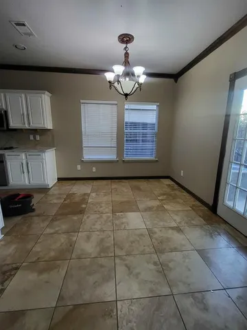 a view of an empty room with a kitchen