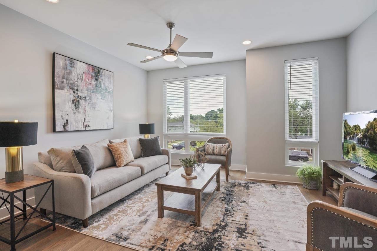 514 West South Street Raleigh, NC 27601 - Photo 20 of 41 a living room with furniture a window and a flat screen tv