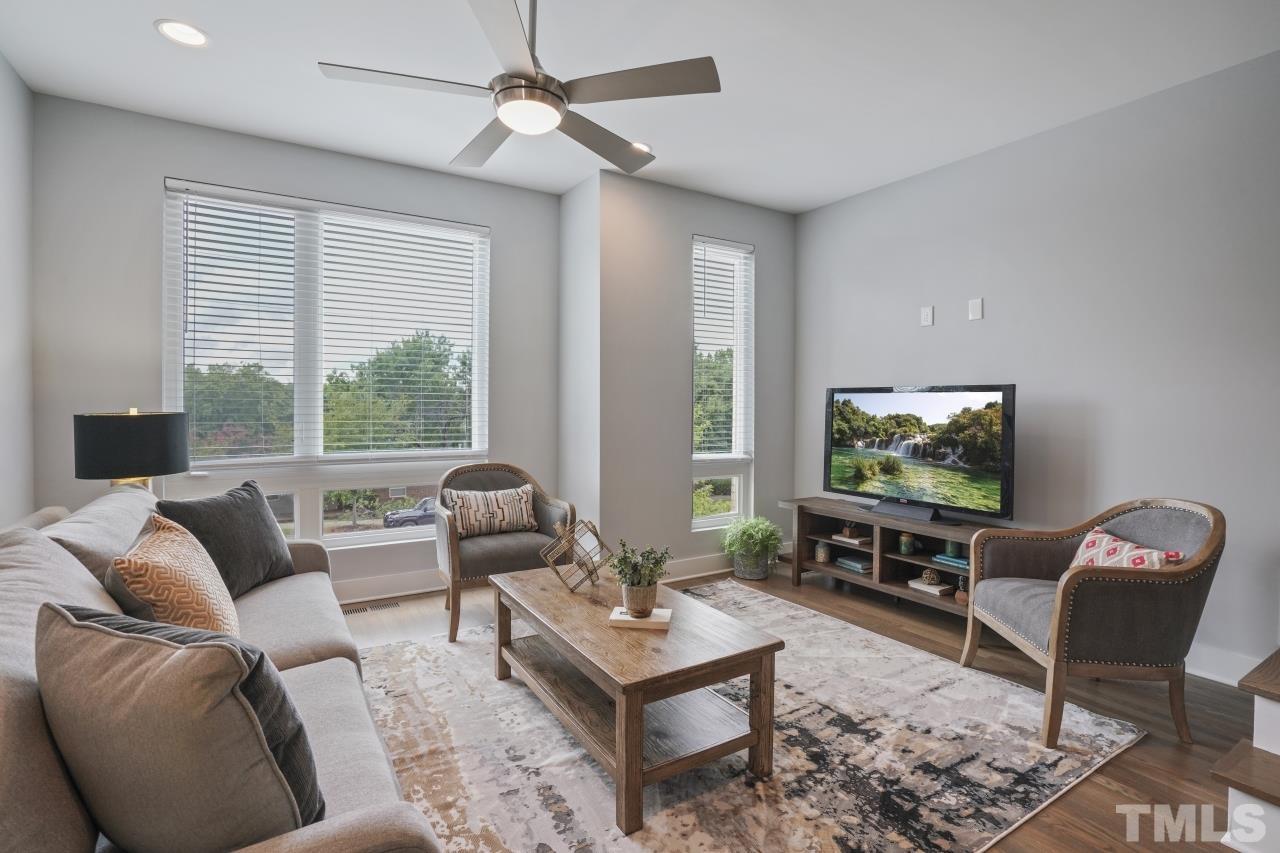 514 West South Street Raleigh, NC 27601 - Photo 21 of 41 a living room with furniture a large window and a flat screen tv