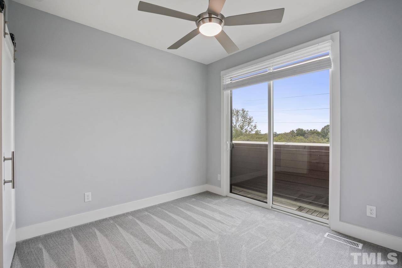 514 West South Street Raleigh, NC 27601 - Photo 27 of 41 an empty room with chandelier fan and windows