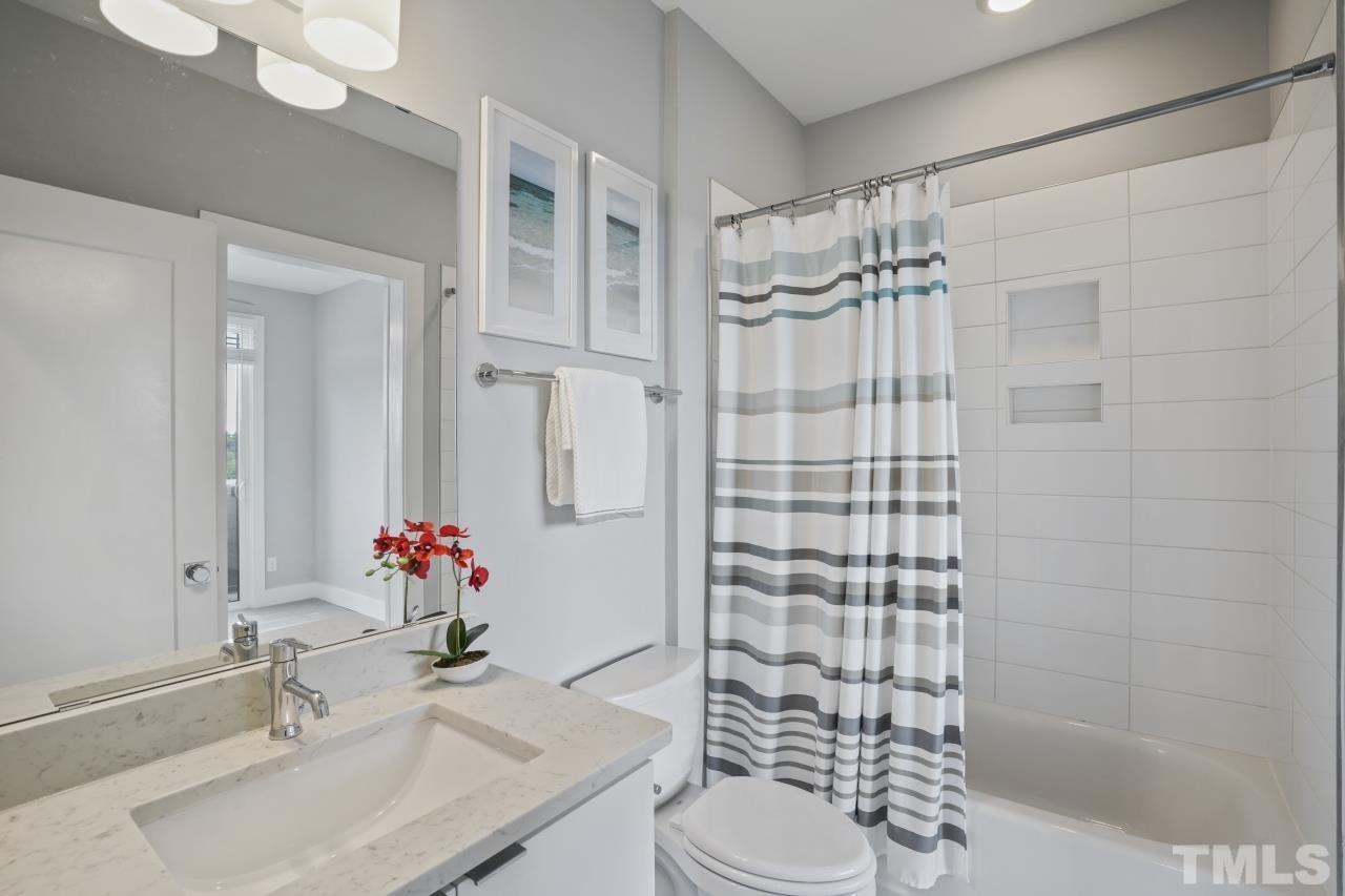514 West South Street Raleigh, NC 27601 - Photo 28 of 41 a bathroom with a sink toilet and shower