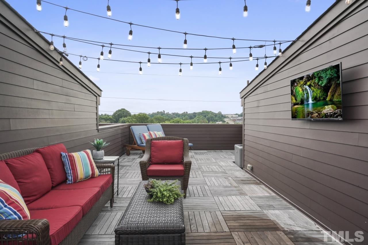 514 West South Street Raleigh, NC 27601 - Photo 32 of 41 a roof deck with a couch and potted plants