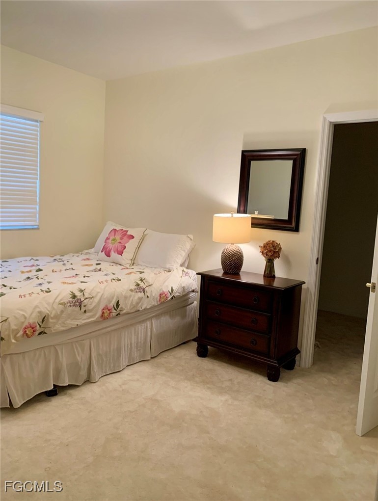 9053 Prosperity Way Fort Myers, FL 33913 - Photo 16 of 27 a bedroom with a bed and window