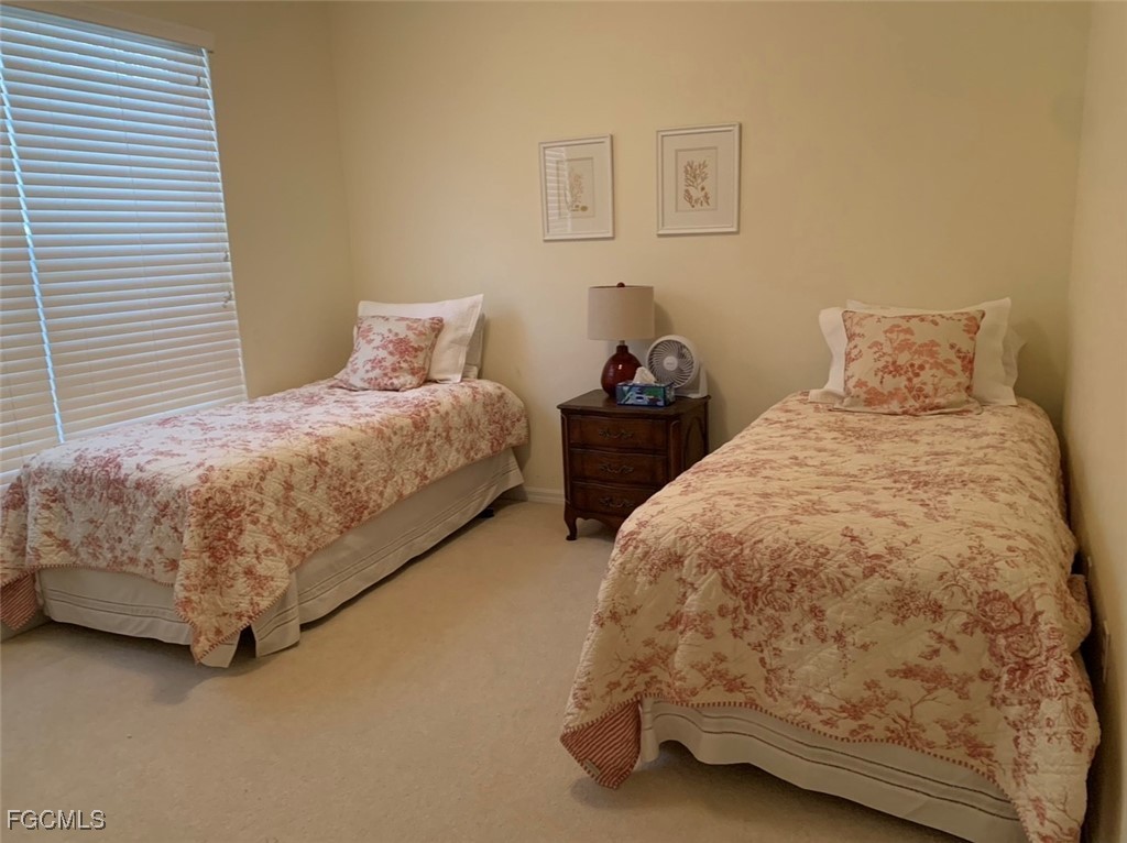 9053 Prosperity Way Fort Myers, FL 33913 - Photo 17 of 27 a bed sitting in a bedroom next to a lamp
