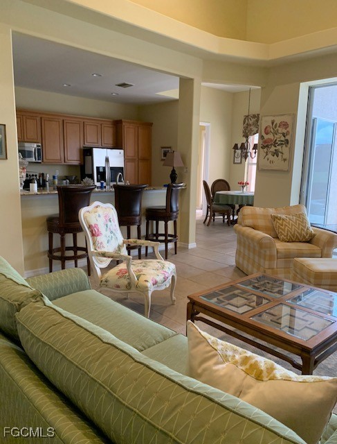 9053 Prosperity Way Fort Myers, FL 33913 - Photo 3 of 27 a living room with furniture and a dining table