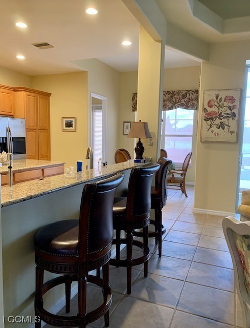 9053 Prosperity Way Fort Myers, FL 33913 - Photo 6 of 27 a kitchen with a dining table and chairs