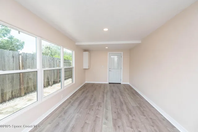 a view of wooden floor and windows in a room