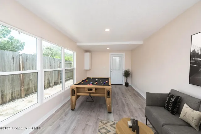 a living room with furniture and a large window