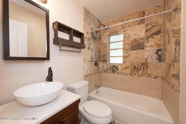 a bathroom with a sink toilet a mirror and shower