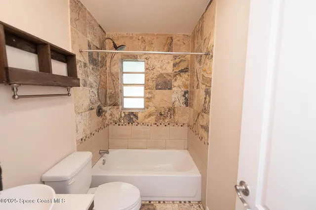 a bathroom with a toilet and a bathtub