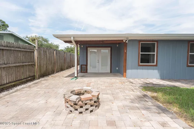 a view of a house with wooden floor and a fence