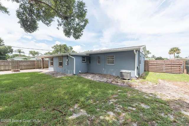 a backyard of a house with table and chairs