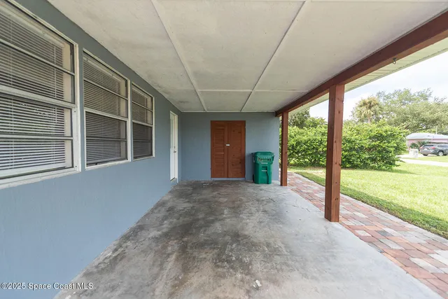a view of empty room with window and front door