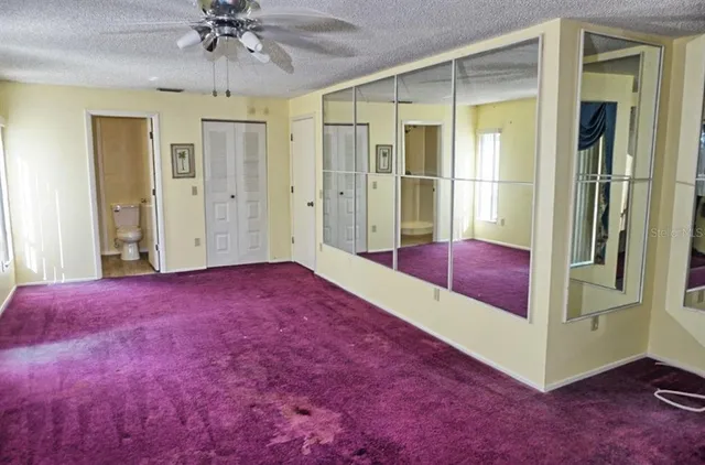 a view of an empty room with a chandelier