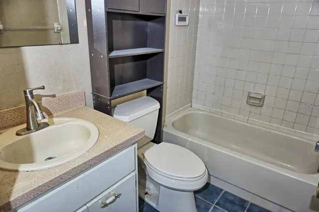 a bathroom with a sink a toilet and bathtub