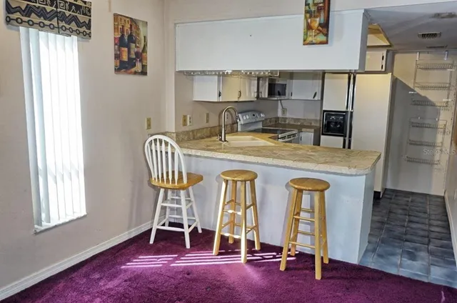 a view of a kitchen with granite countertop a sink and a granite counter top