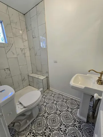 a white toilet sitting next to a bathroom sink
