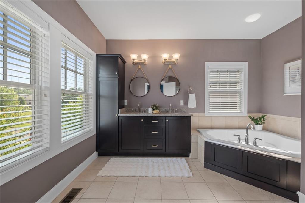 403 Cayuga Circle Mars, PA 16046 - Photo 29 of 50 a bathroom with a tub a double vanity sink and mirror