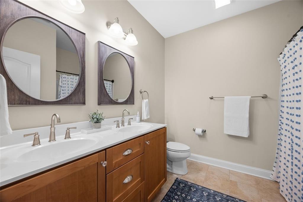403 Cayuga Circle Mars, PA 16046 - Photo 38 of 50 a bathroom with a double vanity sink and a mirror