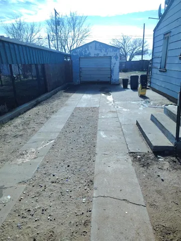 a view of backyard with wooden fence