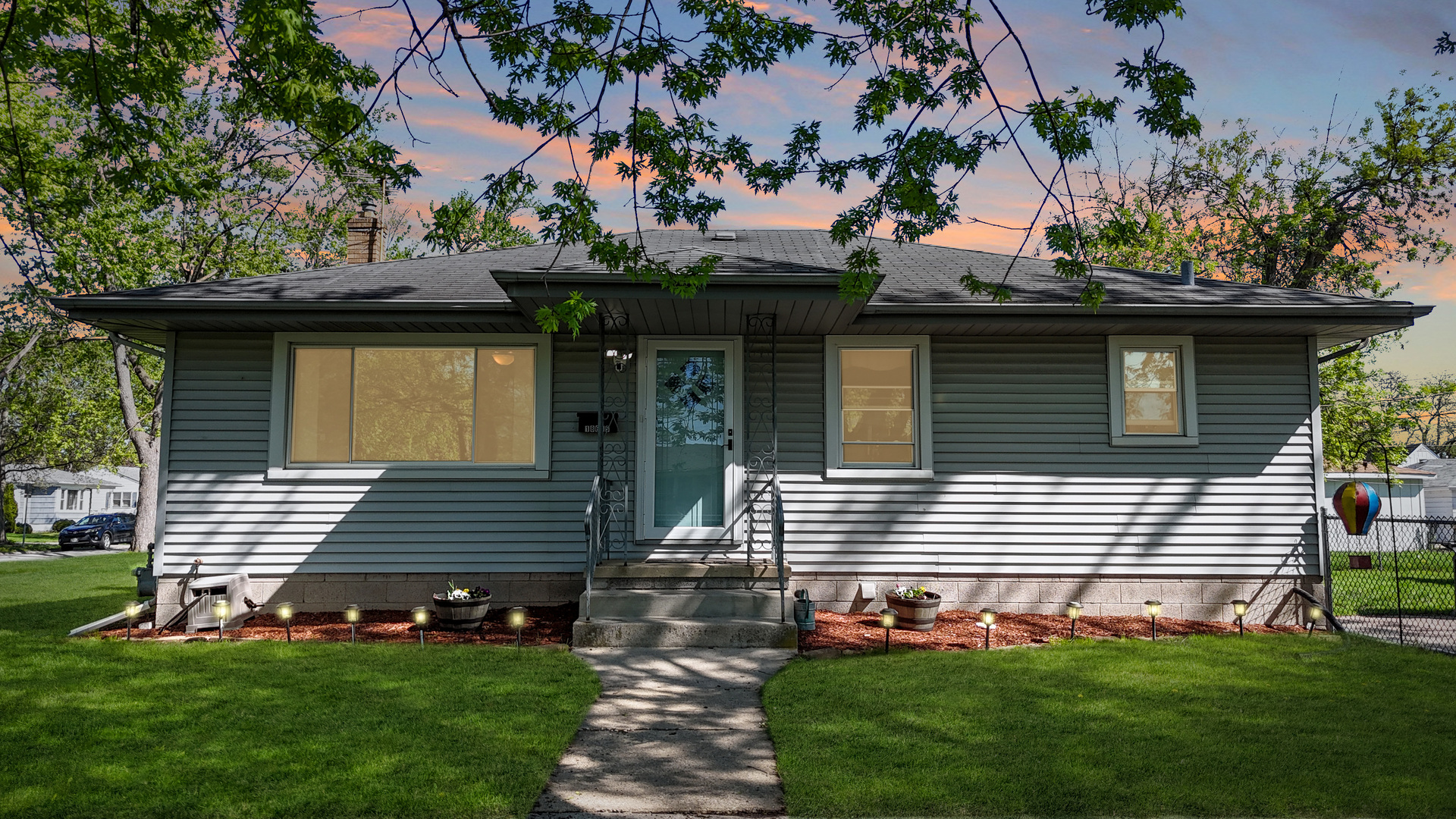 18655 Sherman Street Lansing, IL 60438 - Photo 3 of 21 a front view of a house with a garden