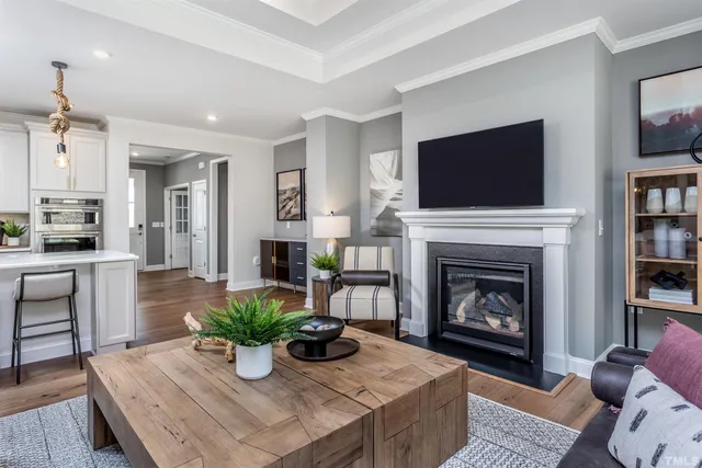 a living room with furniture a flat screen tv and a fireplace