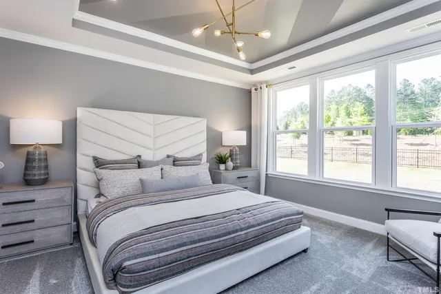 a bedroom with a large bed and a large window