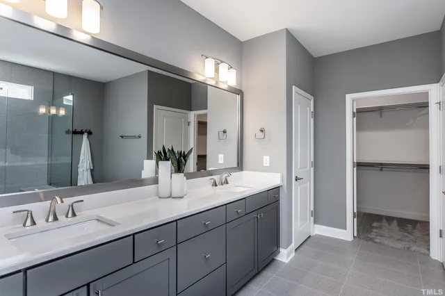 a bathroom with double sink and a mirror