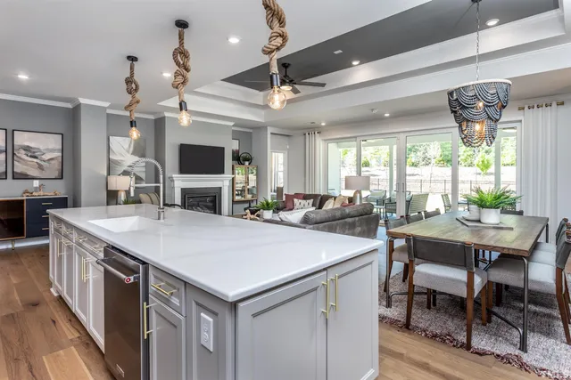 a large kitchen with a table chairs and a large window