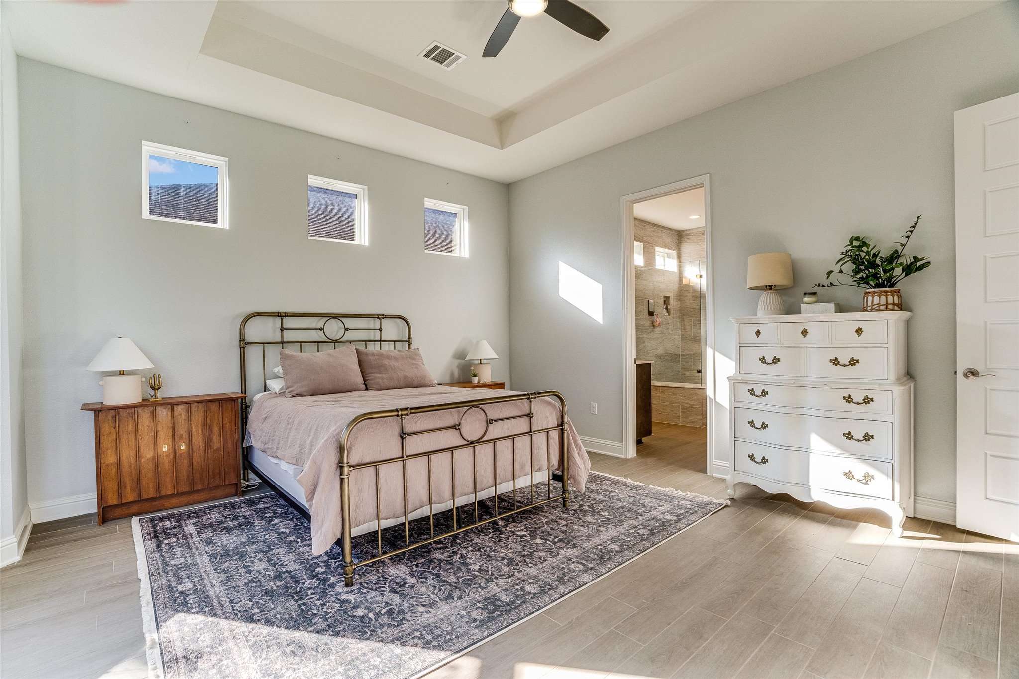 5205 Mandevilla Drive Austin, TX 78739 - Photo 11 of 20 a bedroom with a bed and dresser