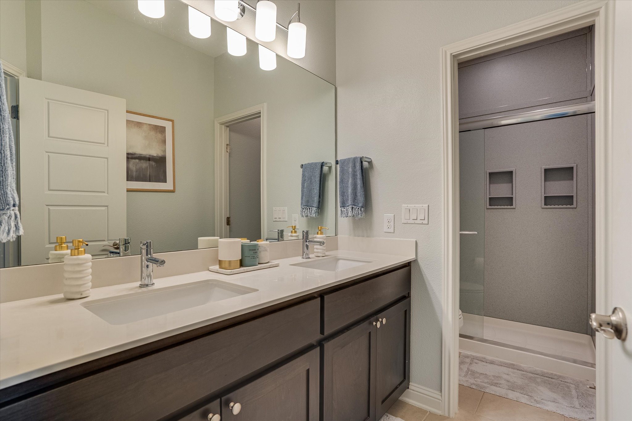 5205 Mandevilla Drive Austin, TX 78739 - Photo 17 of 20 a bathroom with a double vanity sink and a mirror