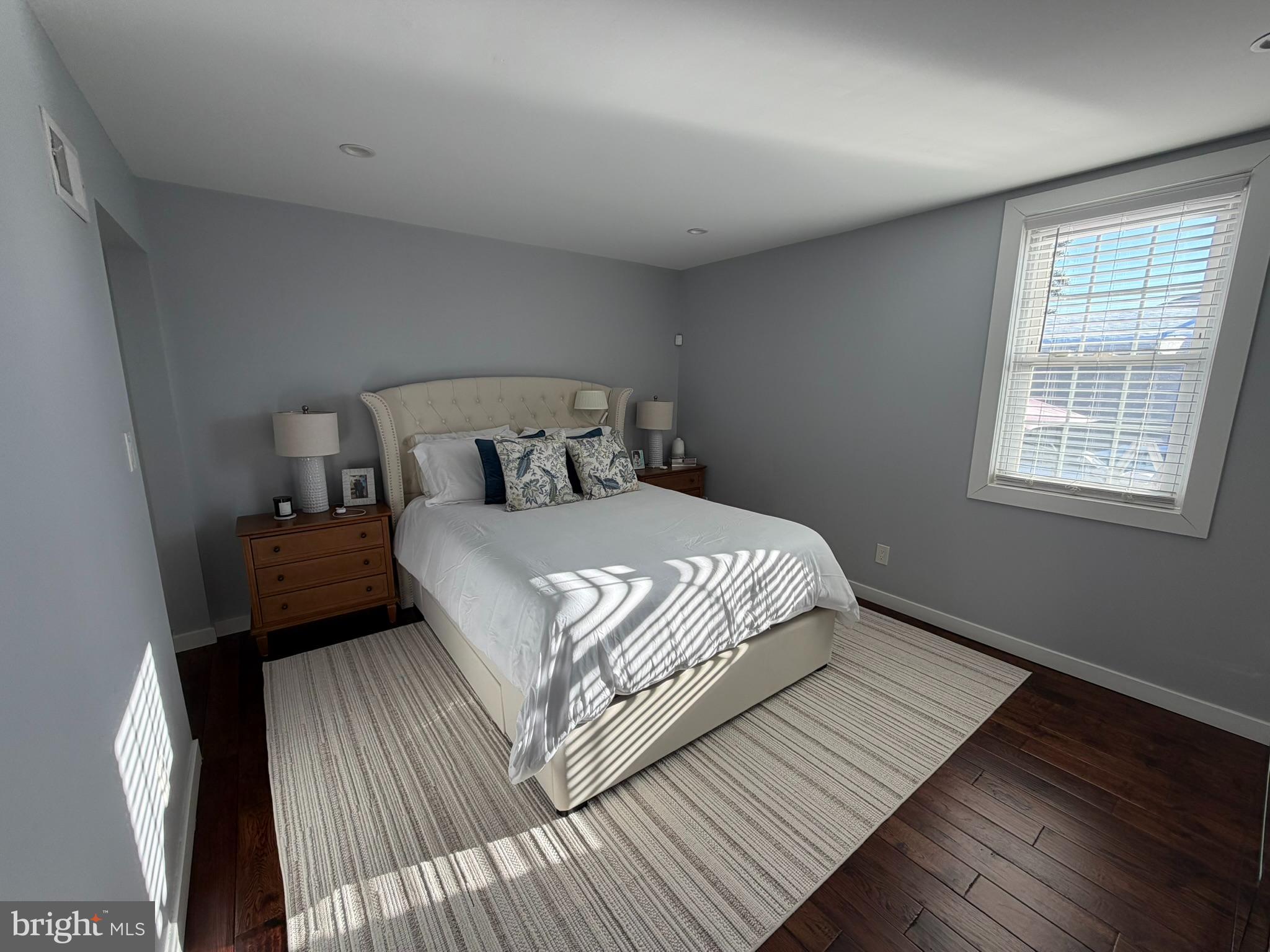 8101 Large Street Philadelphia, PA 19152 - Photo 16 of 30 a bedroom with a bed a mirror and a window