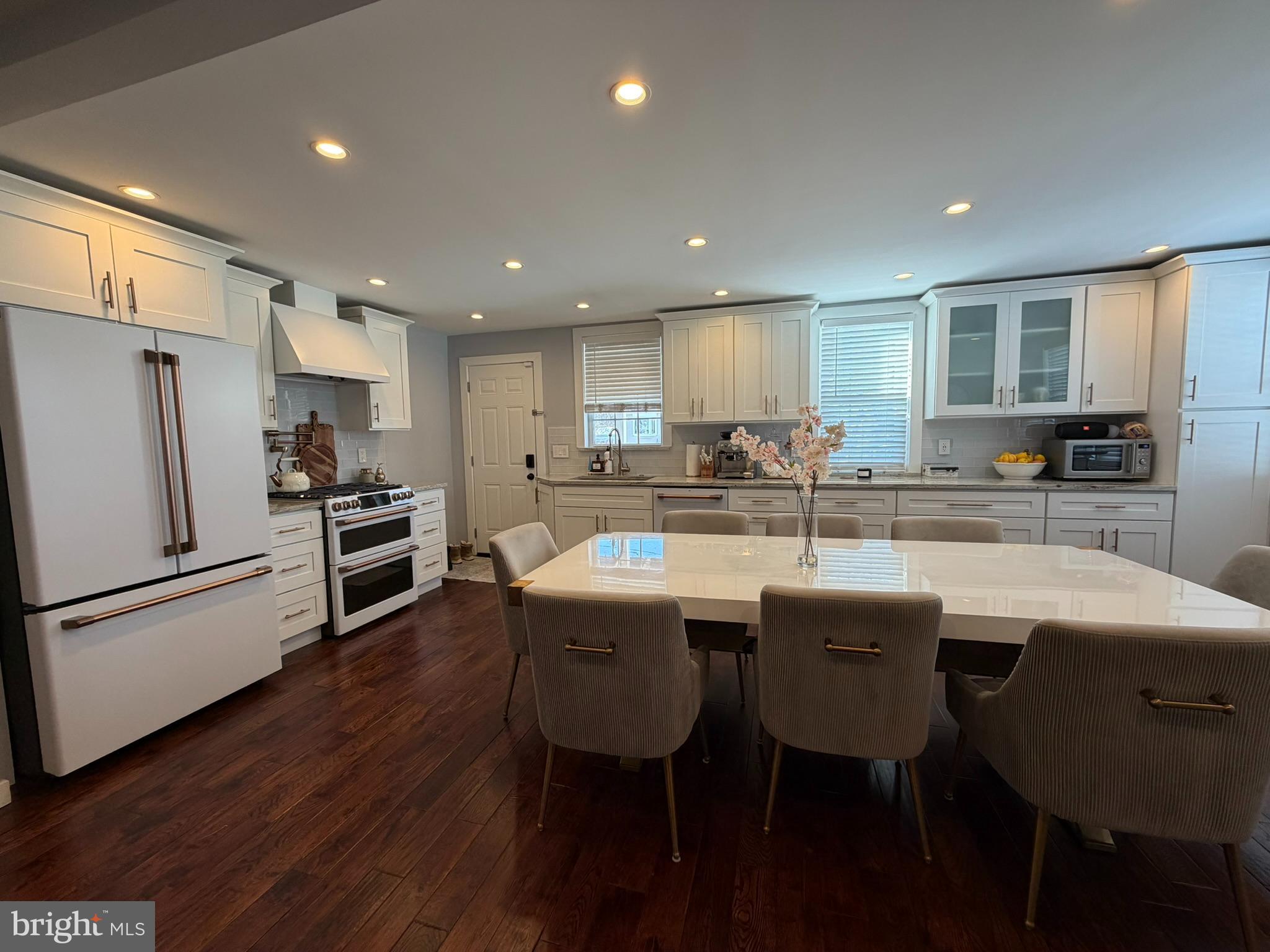 8101 Large Street Philadelphia, PA 19152 - Photo 10 of 30 a kitchen with stainless steel appliances granite countertop a table chairs sink refrigerator and cabinets