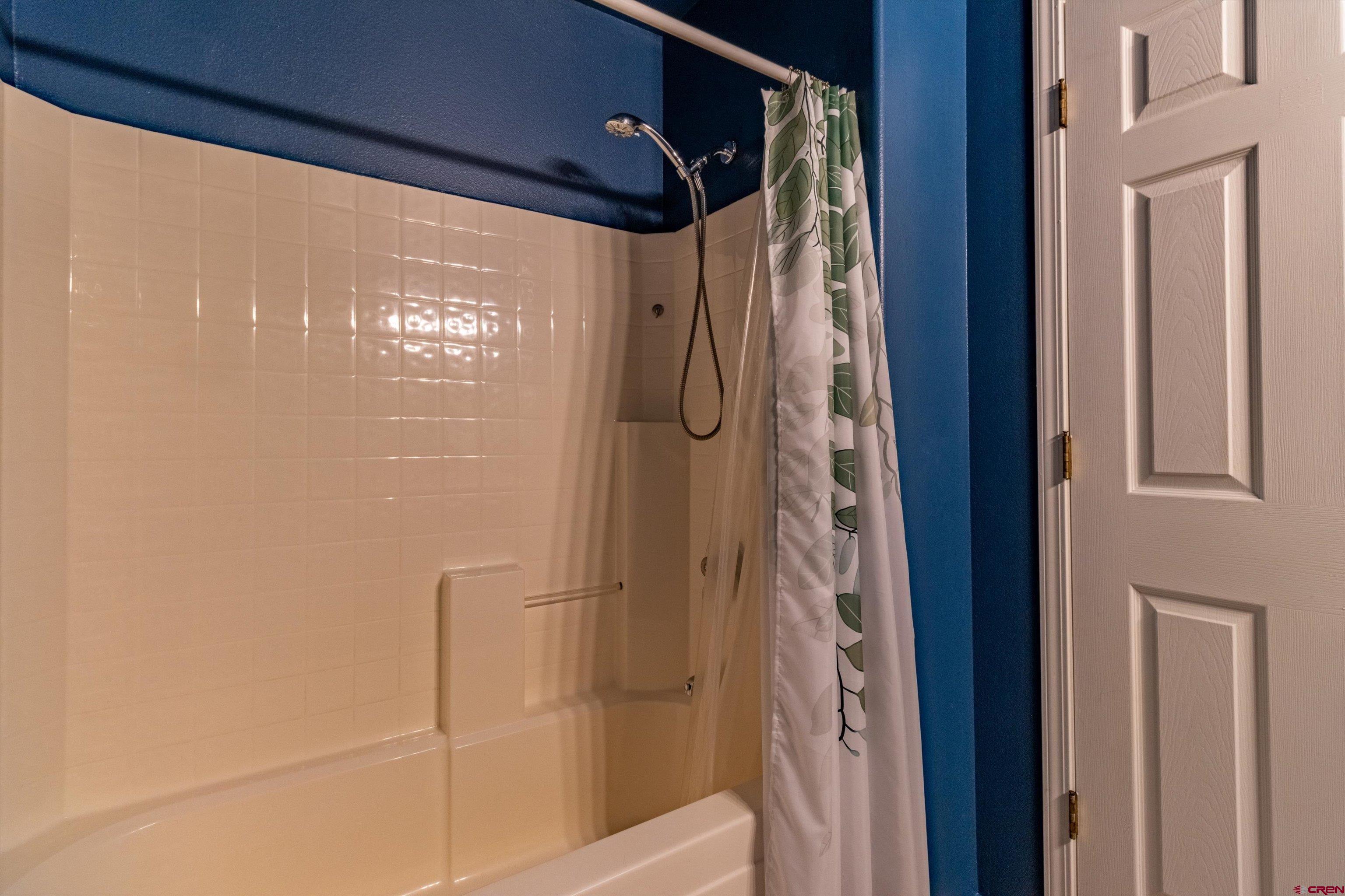 1100 Goeglein Gulch Road, Unit 235 Durango, CO 81301 - Photo 16 of 29 a bathroom with a glass shower door