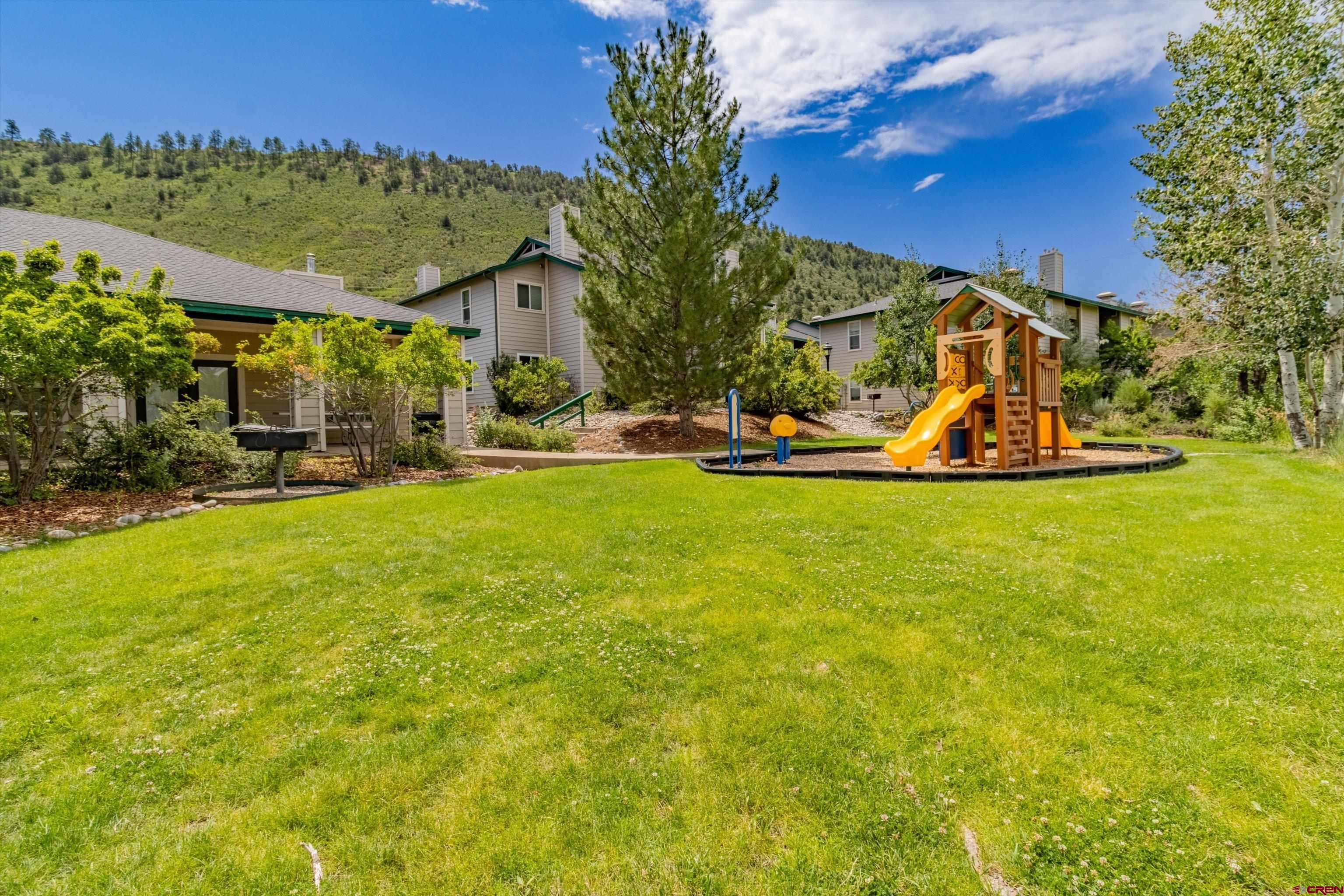 1100 Goeglein Gulch Road, Unit 235 Durango, CO 81301 - Photo 26 of 29 a view of a house with a big yard and potted plants