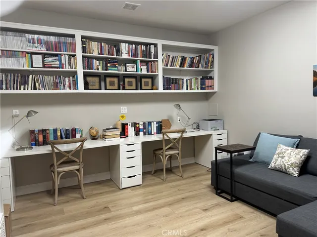 a living room with furniture and a book shelf