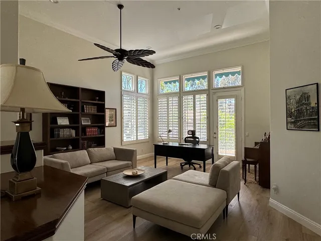 a living room with furniture a table and a large window