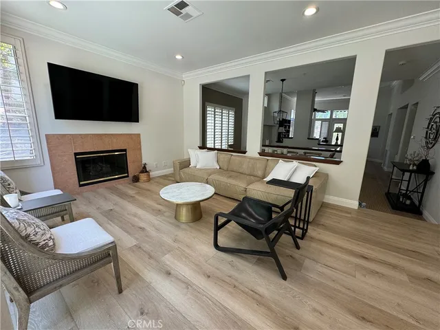 a living room with furniture a flat screen tv and a fireplace