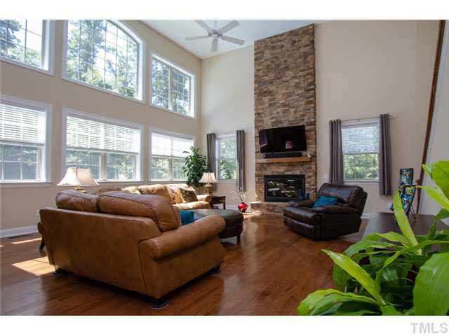 200 Swift Creek Crossing Durham, NC 27713 - Photo 12 of 25 a living room with fireplace furniture and a flat screen tv