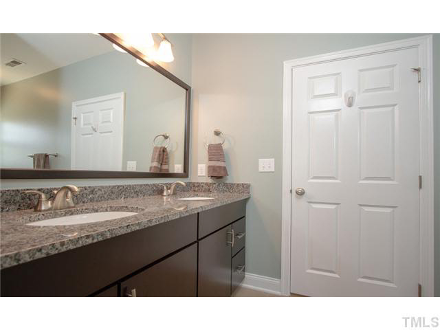 200 Swift Creek Crossing Durham, NC 27713 - Photo 18 of 25 a bathroom with a sink a vanity and a mirror