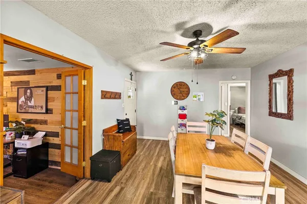 a view of a dining room with furniture and a chandelier