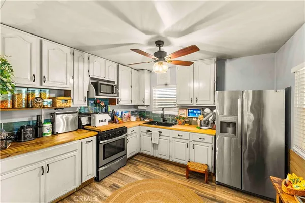 a kitchen with stainless steel appliances a refrigerator sink and cabinets
