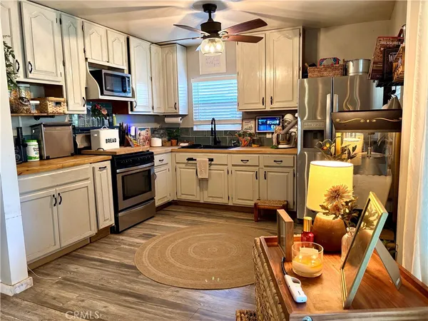a kitchen with stainless steel appliances granite countertop a stove refrigerator sink and cabinets