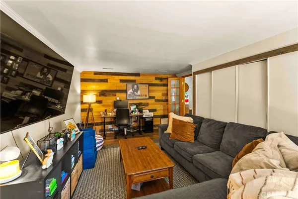 a living room with furniture and a floor to ceiling window