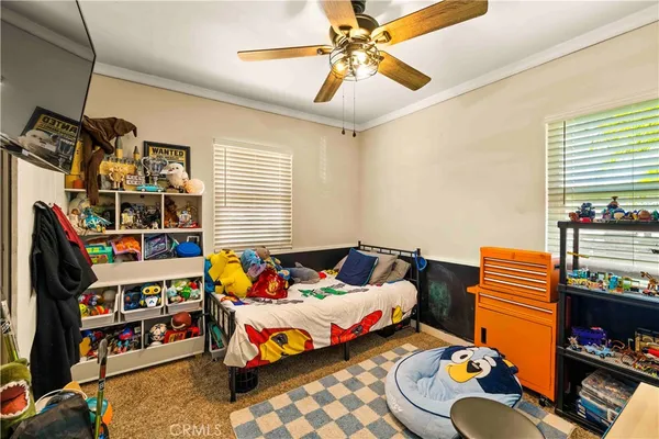 a bedroom with furniture and a book shelf